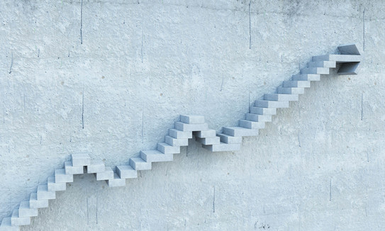 Stepped stairs protrude from a gray wall.